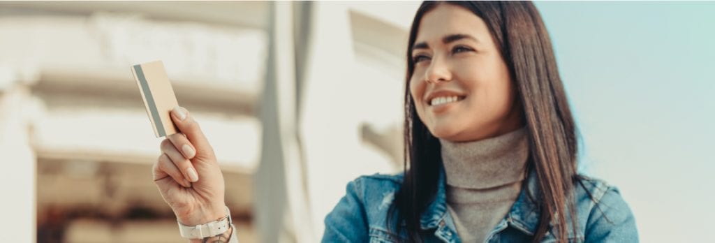 Girl holding up a credit card