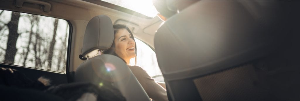 lady in car smiling