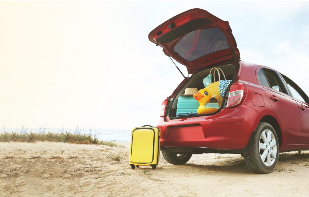car trunk being filled by summer beach toys